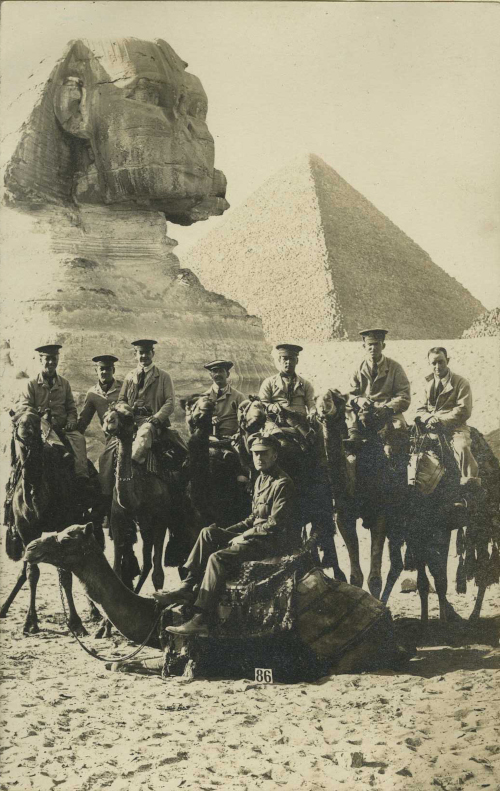 Black and white photograph of a group of military inpatients posing for a photograph in front of the Sphinx and Great Pyramid of Giza, 1914-1918. Ref YMCA/4/1/1/C/28.